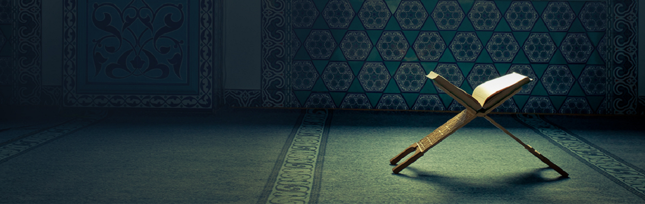 An open Quran resting on a wooden stand in a mosque